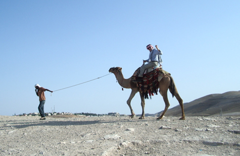 Fr. Dease riding on a camel