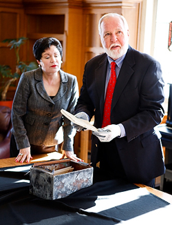 Cheryl and John O'Shaughnessy, grandson of benefactor I.A. O'Shaughnessy, examine the contents of the hall's time capsule.