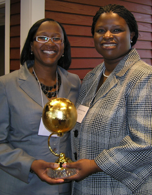 Clinical Law Fellow Artika Tyner (left), and Associate Professor Nekima Levy-Pounds, director of the Community Justice Project, pose with the Jimmy and Rosalynn Carter Partnership Award for Campus-Community Collaboration June 17. (Photo credit: Hamline University.) 