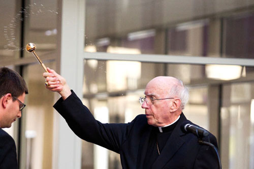 Archbishop Emeritus Harry Flynn blesses the Anderson Athletic and Recreation Complex at its dedication Wednesday.