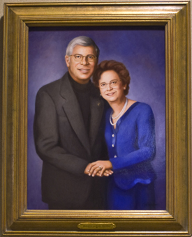A portrait of Quent and Sally Hietpas, painted by artist Cyd Wicker, hangs outside School of Law Room 244, now named in honor of the couple. / Phto by Don Zhou