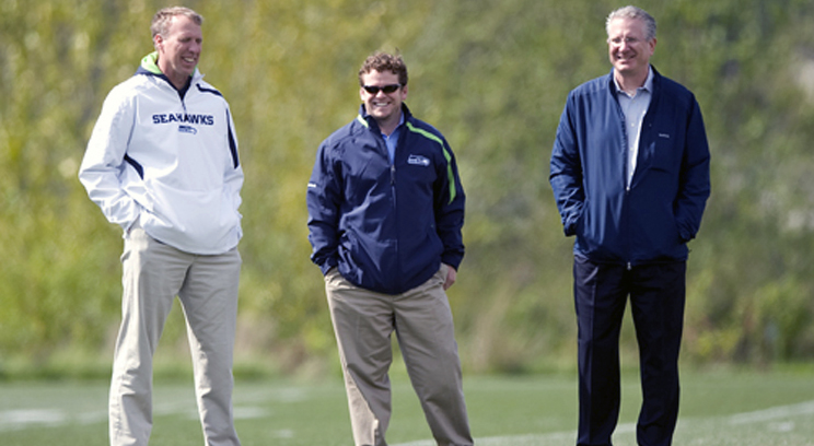 The rise of the Seattle Seahawks has coincided with 2010 arrival of St. Thomas alum John Schneider, center, as the team's general manager and executive vice president. (Seattle Seahawk's photo.)