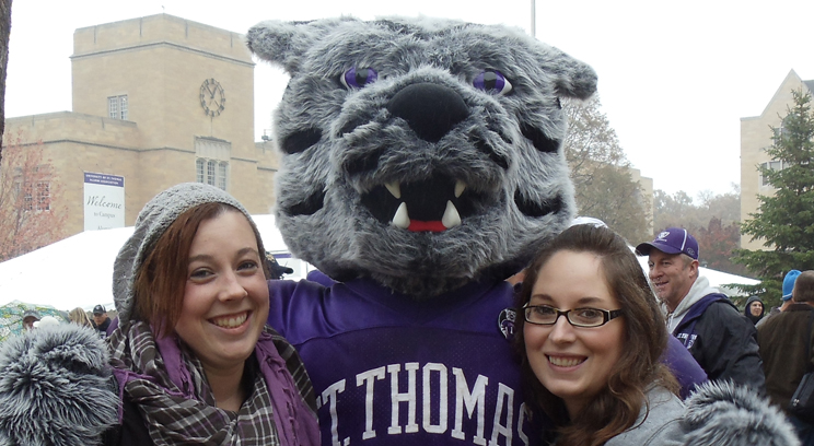 Sarah Pherson, left, gives Tommie a Homecoming hug with Christina Haubrich.