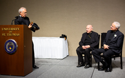 Father John Malone, left, cracks a joke as Archbishop Emeritus Harry Flynn and Father Dease look on.