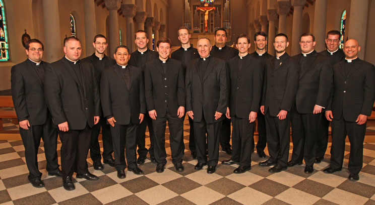 Completing their studies for the priesthood at the St. Paul Seminary School of Divinity this year are, from the left: Adam Westphal, Jacob Greiner, John Drees, Fabian Moncada, Brian Park, James Peterson, Andrew Brinkman, Seminary Rector Monsignor Aloysius Callaghan, Manuel Gomez, Leonard Andrie, Andrew Jaspers, Joah Ellis, Adam Hamness, Andrew Stueve and Luke Marquard. Spencer Howe, who completed his studies in Rome for the Archdiocese of St. Paul and Minneapolis, is not pictured.