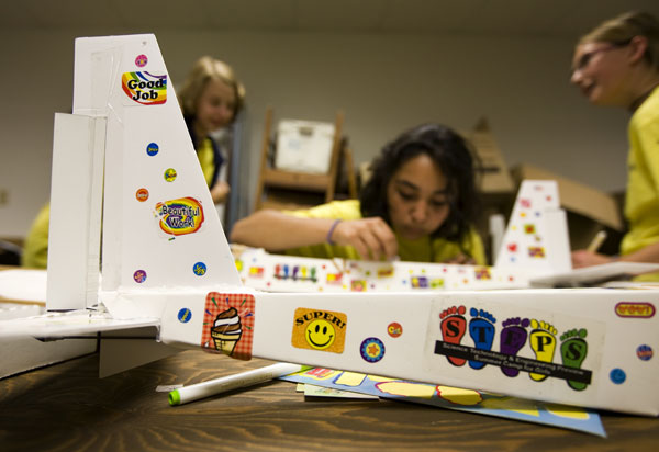 STEPS campers prepare their airplanes for fly night. (St. Thomas photo by Mike Ekern.)