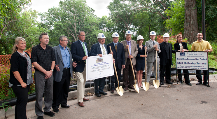 A host of firms and individuals are working together to build the home in Edina. Many of them were on hand for the groundbreaking at the constuction site Tuesday, July 9. From the left are Stephanie Angen, JMS Custom Homes; Scott Whitworth, JMS Custom Homes; Jeff Schoenwetter, JMS Custom Homes; John Everett, Edina Realty; Bob Strachota, Shenehon Co.; James Gooley, St. Thomas Development Office; Herb Tousley, St. Thomas real estate programs; Teresa Lingg, St. Thomas real estate student; Ted Johnson, St. Thomas real estate student; Father John Malone, St. Thomas Office for Mission; Nancy Schoenwetter, JMS Custom Homes; and Matt Hannish, JMS Custom Homes.