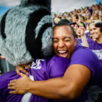 A student gives Tommie the mascot a hug during the Tommie-Johnnie football game Sept. 21 in O'Shaughnessy Stadium. St. Thomas lost to Saint John's 18-20. (Photo by Mike Ekern '02)