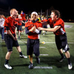 From left: SJV seminarians Greg Parent, Vince Fernandez, and James Smyth celebrate a touchdown. (Photo by Mike Ekern '02)