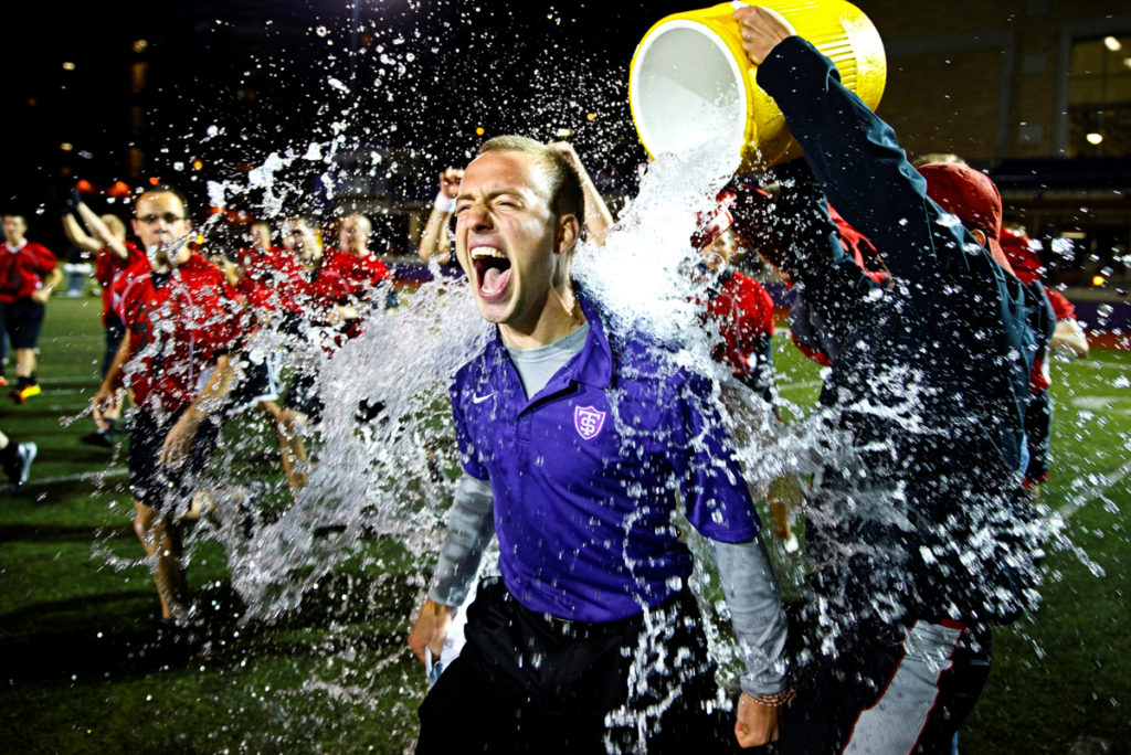 SJV head coach Nathanial Binversie gets a victory shower from his team. (Photo by Mike Ekern '02)