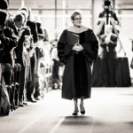 President Julie Sullivan walks past an applauding audience as she processes into the Anderson Athletic and Recreation Complex field house during her inauguration as the 15th president of St. Thomas on Oct. 17. (Photo by Mike Ekern '02)