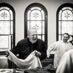 Cardinal Timothy Dolan laughs in the sacristy of the Chapel of St. Thomas Aquinas following a Mass celebrating the 20th anniversary of Catholic Studies Oct. 26 (Photo by Mike Ekern '02)