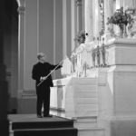 Father Lavin lights a candle in the Chapel of St. Thomas Aquinas in 1966.