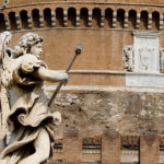A statue of Angel with Sponge on the Ponte Sant'Angelo stands in front of the Castel Sant'Angelo (also known as the Mausoleum of Hadrian).  (Mike Ekern/University of St. Thomas)