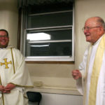 Monsignor Lavin returned to the basement of Ireland Hall on April 3, 2008 to celebrate mass with Father Erich Rutten (left). Lavin whipped up a batch of his famous PB&J sandwiches following the service. (Photo courtesy Josh Hengemuhle)