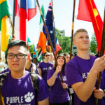 To end the procession, international students carry flags representing their countries of origin. (Photo by Mark Brown)