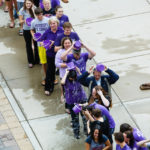 Seen from above, students, faculty and staff pour ice cold water on themselves. (Photo by Mark Brown)