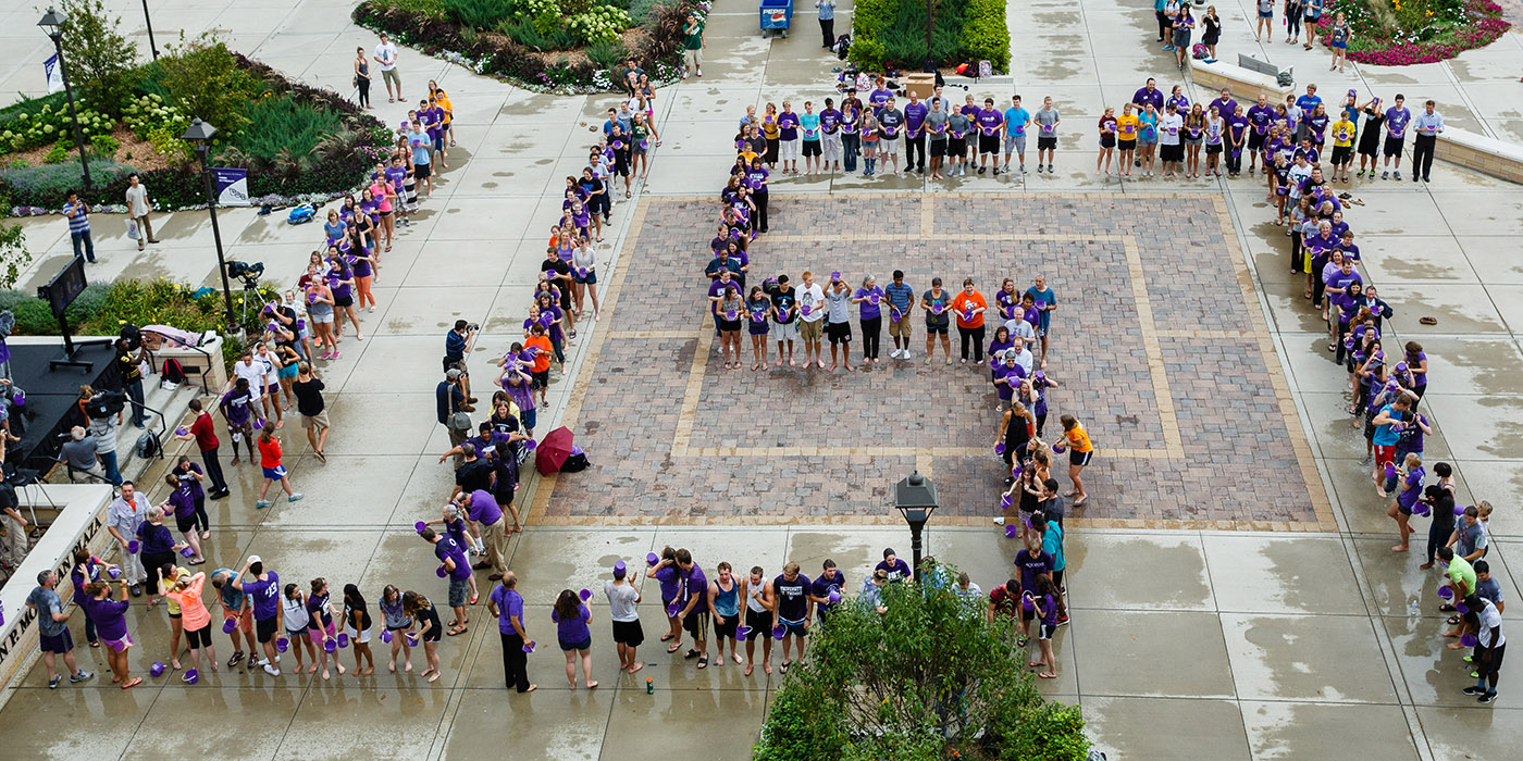 Students, staff and faculty, spelling out UST in giant letters, douse themselves with cold water during an ALS Ice Bucket Challenge event on John P. Monahan Plaza on Sept. 4, 2014.