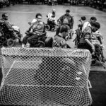 Players fight for the ball in front of the net during the Minnesota Saints PowerHockey Cup game against the Calgary Selects on July 21 at The Legendary Roy Wilkins Auditorium in downtown St. Paul. PowerHockey is a sport for disabled athletes with rules similar to hockey. Several UST alums play and coach in the PowerHockey League.