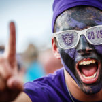 A student cheers for St. Thomas at the Tommie Johnnie football game.