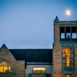 The moon hangs over O'Shaughnessy-Frey Library.