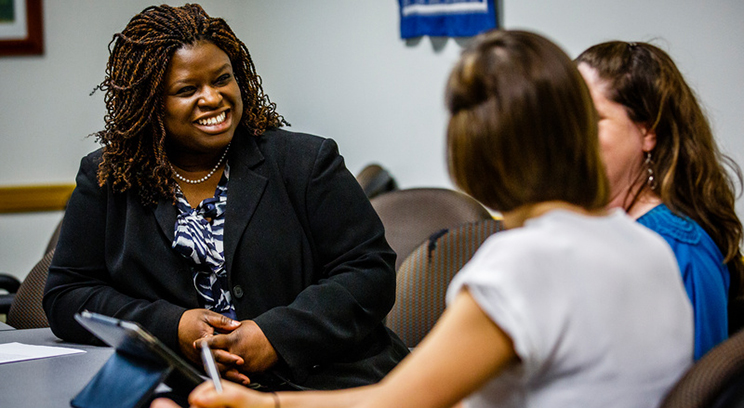 Law professor Nekima Levy-Pounds laughs as she stages a scene with students during clinical rounds April 8, 2014 at the Interprofessional Center for Counseling and Legal Services.