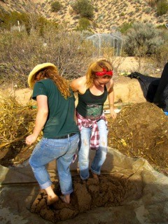 Meredith Heneghan ’16, left, and Alyssa Adkins ’15 mix cob, the material used to construct buildings and other structures at Quail Springs. Cob is a mixture of sand, clay, hay and water. 