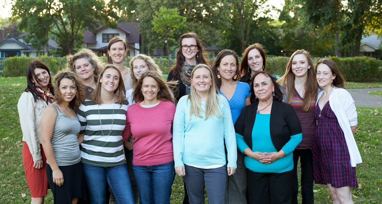 Erica Gerrity (third from left, second row) with the staff of Isis Rising. / Photo provided