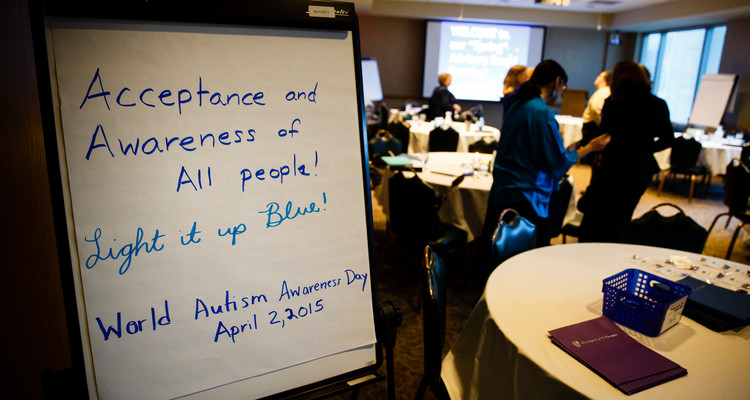 A photo of a sign reading "Acceptance and Awareness of All People! Light it up Blue! World Autism Awareness Day April 2, 2015" is shown during a meeting of the College of Education, Leadership and Counseling Special Education advisory board March 4, 2015 in Terrence Murphy Hall.