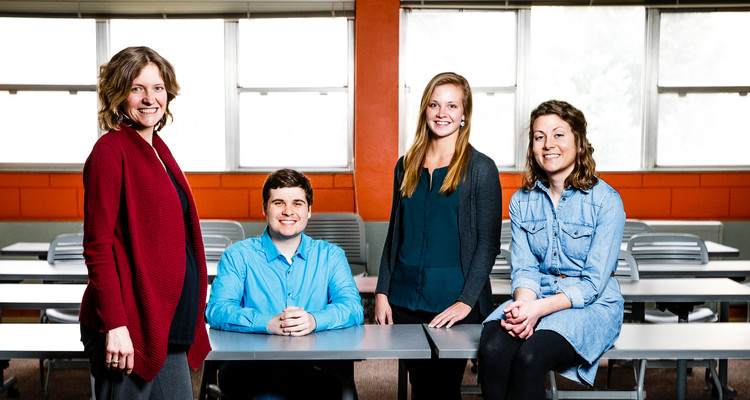 Justice and Peace Studies students and their professor pose for a photo following a class session in the Summit Classroom Building April 7, 2015. From left: JPST professor Amy Finnegan, Tim Stammeyer, Kate Weyenberg, and Kaitlyn Gathje. Taken for CAS Spotlight magazine.