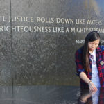 Qunimill Lei reads from the Maya Lin-designed Civil Rights Memorial, Montgomery, Alabama. Photo by Kathryn Hubly.