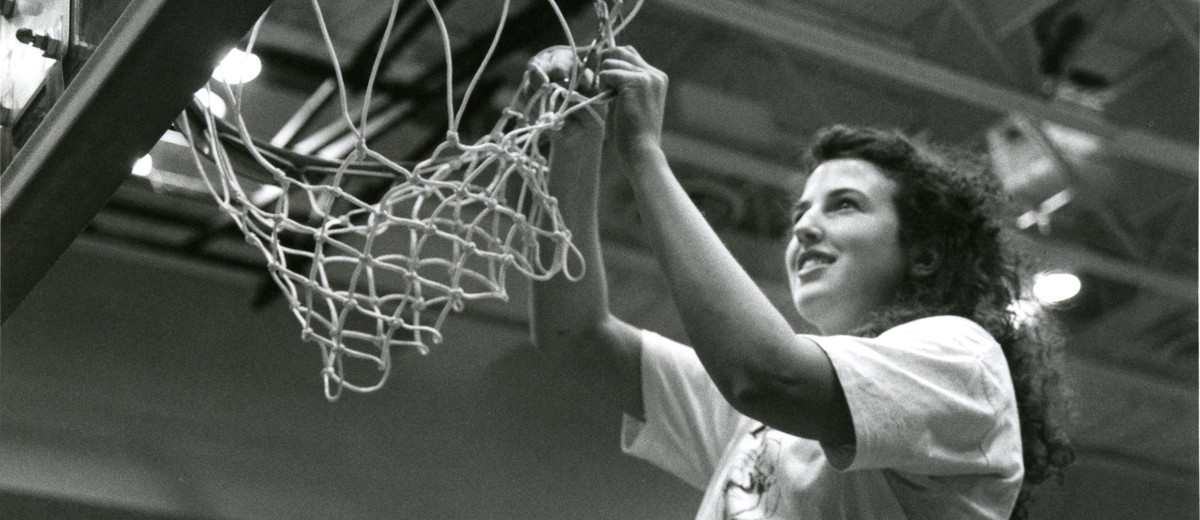 Suzy Bouquet cuts down the net following the 1991 women's basketball national championship game.