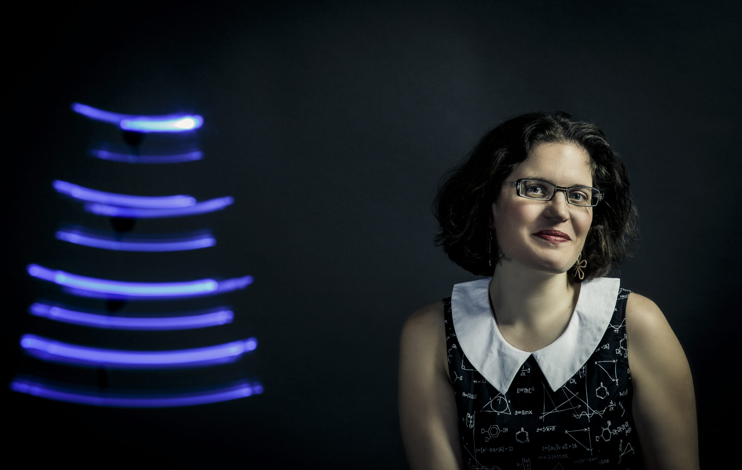 School of Engineering professor AnnMarie Thomas poses for a studio portrait with light-painted tracks made by LEDs March 3, 2015. Taken for the School of Engineering newsletter. Thomas often explores play concepts as a way of teaching engineering.