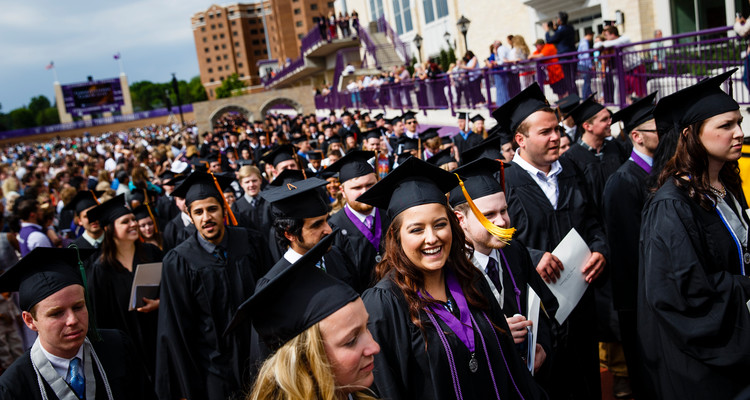 A student laughs as she leaves O'Shaughnessy Stadium during the undergraduate commencement ceremony May 23, 2015.