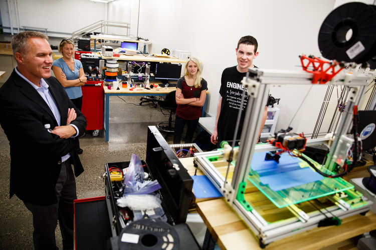 Austin Otto (Mechanical Engineering) far right, talks with CiCi's Pizza CEO Darin Harris, far left, as Engineering Professor Brittany Nelson-Cheeseman, back left, and Lindsey Bollig (Mechanical Engineering), back right, look on on September 2, 2015 in the Facilities and Engineering Building on south campus in St. Paul. Austin Otto won $10,000.00 through the CiCi's Pizza Photo Scholarship Contest. Otto wrote an essay and snapped a picture of himself in a CiCi's Pizza restaurant. He initially thought he was being interviewed about his 3D Printing engineering research and was surprised by his parents with the check after CiCi's CEO Darin Harris announced that he had won the scholarship.