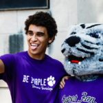 Brazilian international student Gustavo Faria takes a selfie with Tommie before the March Through the Arches.