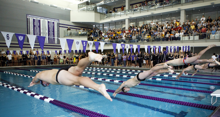 Men's swimming team members launch from the starting blocks during the Tommie Relays, the first intercollegiate meet in the new Anderson Athletic and Recreation Complex aquatic center October 30, 2010.