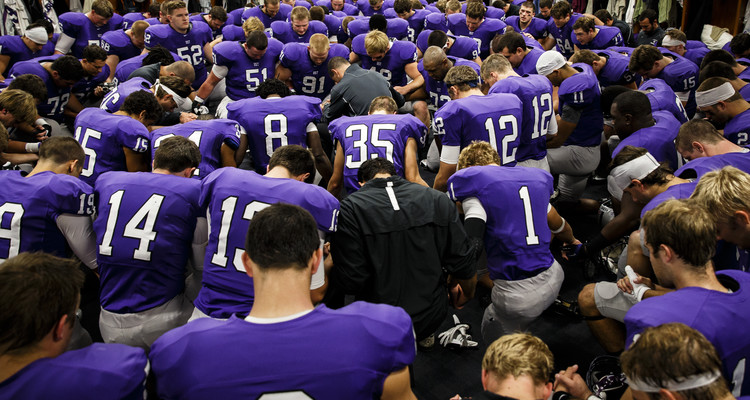 The UST football team huddles and prays in the Anderson Athletic and Recreation Center prior to the start of the Tommie-Johnnie football game on September 21, 2013, at Palmer Field in O'Shaughnessy Stadium in St. Paul. UST lost to St. John's University 20-18.