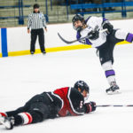 Jordan Lovick fires a shot on goal over a diving defender during a men's hockey game against the University of Wisconsin-Whitewater.