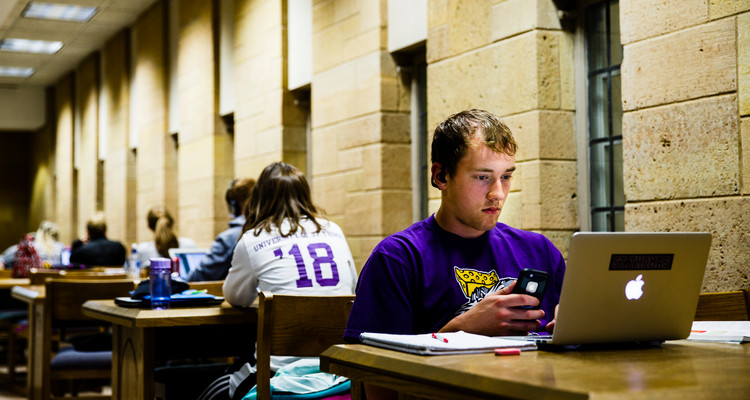 Student Sam Barr studies in O'Shaughnessy-Frey Library May 18, 2015 during the finals week "study Monday."