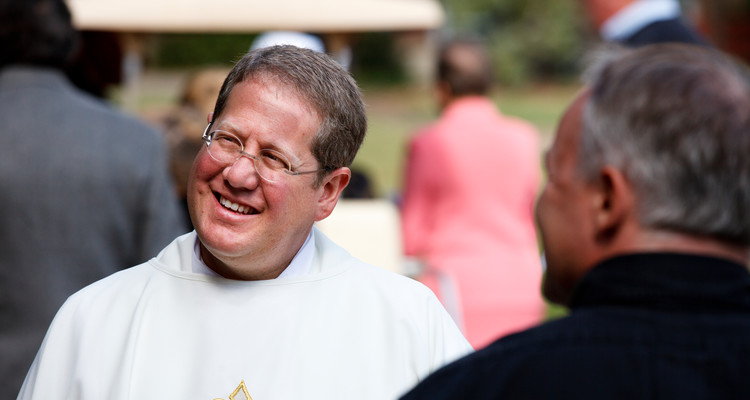 Father Erich Rutten, director of campus ministry at the University of St. Thomas, talks outside following the funeral mass of Monsignor James Lavin at the Chapel of St. Thomas Aquinas on September 21, 2012.