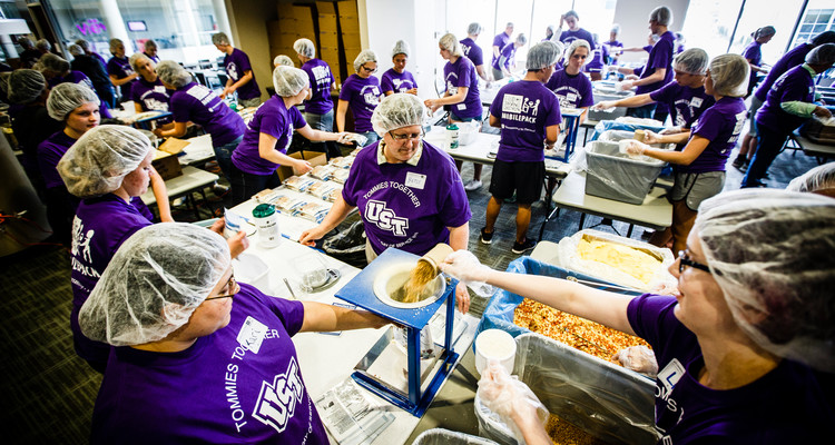 Volunteers bag up prepared meals during the St. Thomas Day of Service mobile pack event May 6, 2015 in the Anderson Student Center's Campus Way. Feed My Starving Children brought mobile supplies to St. Thomas where faculty, staff and student volunteers packed thousands of meals for children without food overseas.