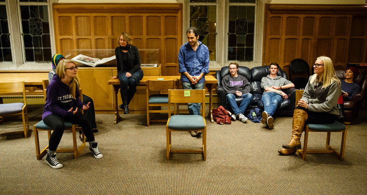 Students act in an improv exercise during an English class in the Leather Room in the O'Shaughnessy-Frey Library Center on October 28, 2015. Members of the Wonderlust Theater participated in a residency on campus with several different classes and programs, working with English and Theater students on improvisation skills and script writing. English professor Amy Muse, back right, and Wonderlust Theater co-Artistic Director Alan Berks, middle back (wearing blue shirt) look on.