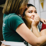 Highland Park Senior High School senior Amaris Holguin hugs an admissions counselor after learning she is a recipient of the Dease Scholarship.