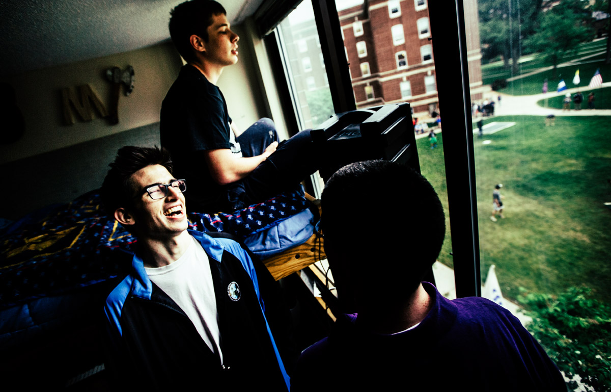Seminarians Paul Hedman (on bed), Kevin Hufnagel (laughing) and Antonio Gutierrez operate the announcers' booth inside the SJV dorm.