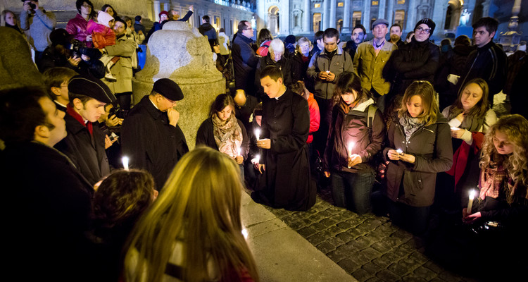 Seminarians, students and advisers from the Bernardi Campus, along with others, pray in front of the Obelisk in St. Peter's Square on Feb. 28, 2013. (From left, front row) Savannah Siegler '14, Keith Dewig, Mike Steffes '13 (standing) and Catherine Huss '15. Photo by Mark Brown