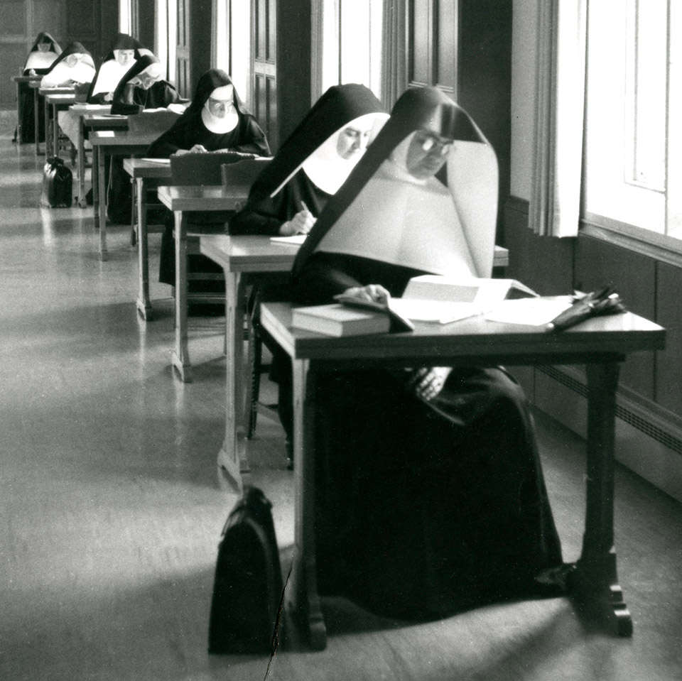 Members of several different female religious order study in the O'Shaughnessy Library at the College of St. Thomas, 1960.