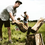 Sam Schultz splits wood.