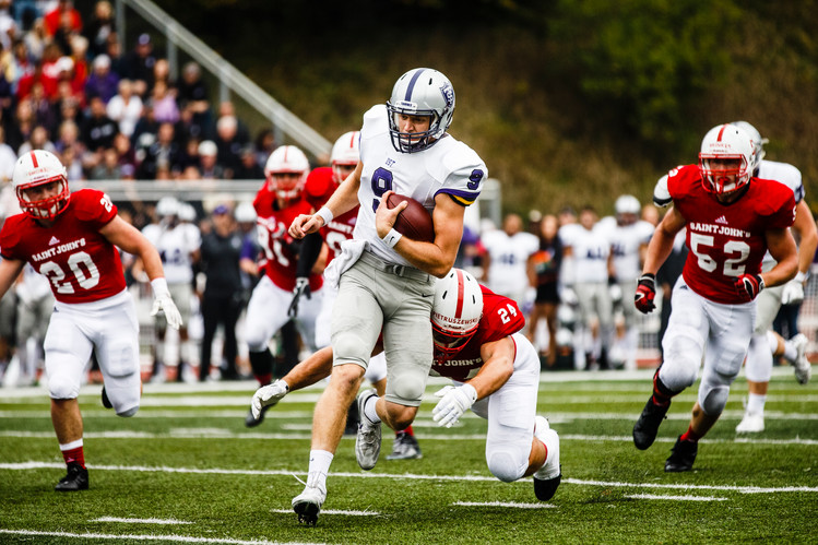 Quarterback Alex Fenske rushes during the 2016 Tommie-Johnnie game in Collegeville.