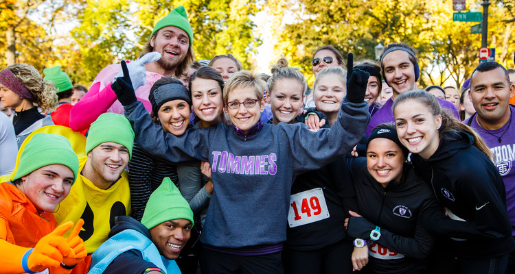 UST President Dr. Julie Sullivan poses for a group photo with students participating in the annual Wellness 5K on Summit Avenue in St. Paul on October 17, 2015.